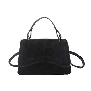 Women's black tote bag with animal leopard pattern embossed texture and crossbody strap