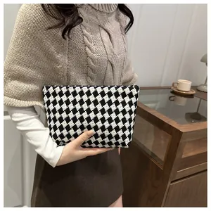 Detail shot of the woven black and white checkered fabric texture and material