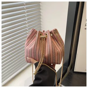 Détails du sac seau à cordon avec motif chevrons rose et breloques en perles blanches