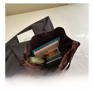Spacious interior of a brown leopard print tote bag showing various daily essentials