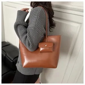 Detail of caramel brown PU leather tote bag set with matching small hanging pouch