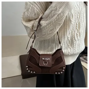 Detail of dark brown leather motorcycle bag with silver rivets and metal buckle