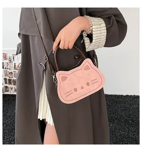 Pink cat-shaped crossbody bag with cute facial stitching and brown leather handles