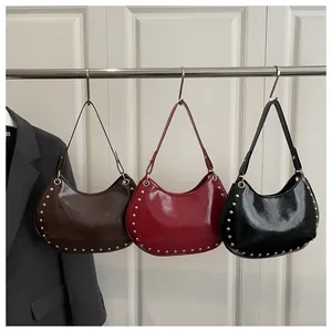 Detailed comparison of hobo shoulder bags in brown, red and black with gold metal studs