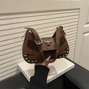 Vintage brown motorcycle shoulder bag with metal rivets and suede patchwork design