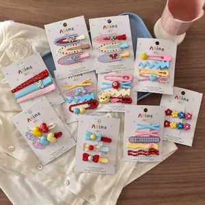 Flat lay detail of cute colorful hair clip sets with bows and bears on card display