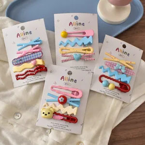 Colorful Korean-style hair clip set with cute bear and bow designs on white shirt
