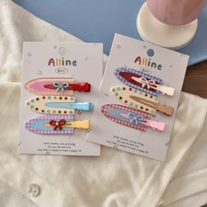 Detail of colorful hair clip set featuring plaid patterns, rhinestones and bow designs