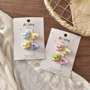 Detail of cute bear-shaped macaron hair clips set with handmade resin details