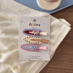 Detailed view of three colorful dopamine style hair clips with bowknot and rhinestone motifs