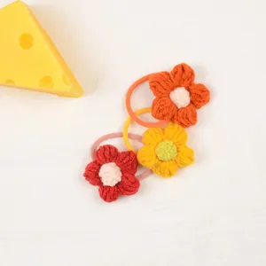 Handmade crochet flower hair ties for girls in vibrant red, yellow and orange colors