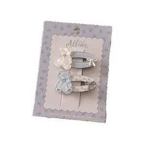 Set mit zwei süßen Bären- und gepunkteten Schleifen-Haarspangen in Creme und Blau