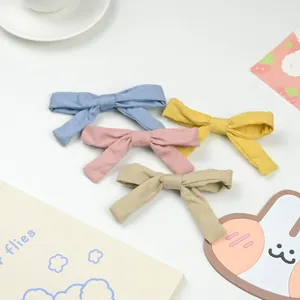 Handmade fabric bow hair clips in pastel blue, pink, yellow and khaki for girls
