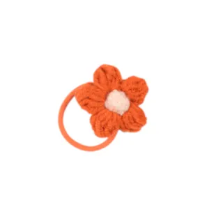 Handmade crochet flower hair tie for girls with orange petals and soft pink center