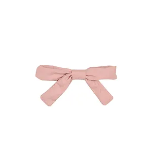 Pale pink fabric bow hair clip for girls with elegant hanging ribbons on white background