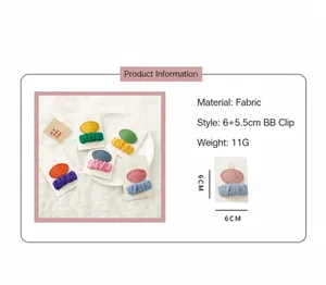 Detail view of colorful fabric hair clips for girls showing dimensions and material texture