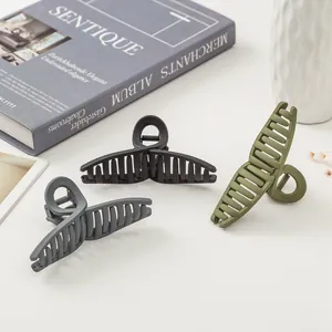 Matte finish oversized shark hair clips in black, grey and olive green minimalist style