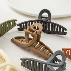 Minimalist matte hair claw clips in various earthy tones with crisscross hollow design