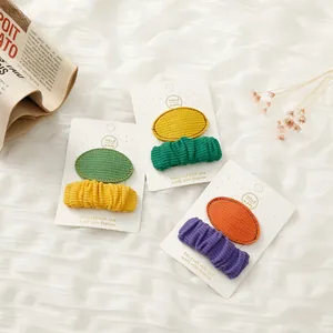 Cute fabric hair clips for girls featuring colorful stitched oval patches in sets of two