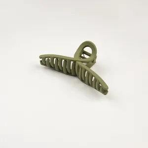 Detail view of olive green matte hair claw clip with sturdy metal spring mechanism