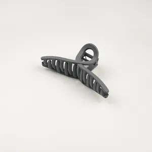 Close-up of matte dark grey crisscross hair claw clip with a secure metal spring