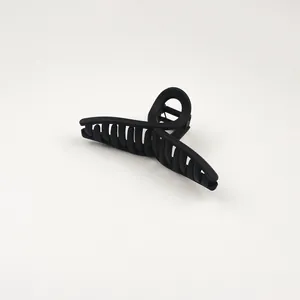 Detail of matte black cross design hair claw clip with strong teeth for hair styling