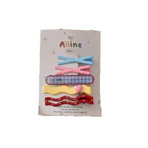 Five-piece colorful Korean style hair clip set with cute bear and bow designs on a card