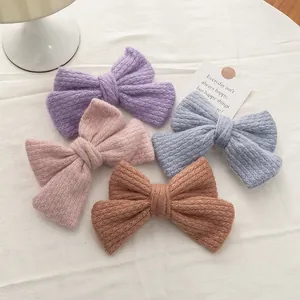 Four knit bow hair clips in pastel colors for women, vintage autumn winter style