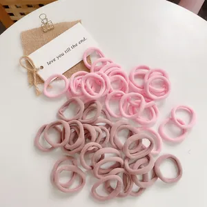 Detail of high-elastic seamless hair ties in pink and mauve colors for daily use