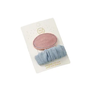 Pink and blue fabric hair clips set on display card for little girls' accessories