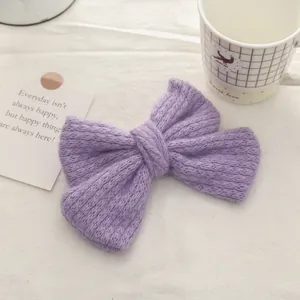 Detail of purple knitted double-layer bow hair clip with soft mohair texture