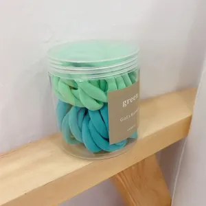 50-piece set of seamless hair ties in green and blue shades within a clear storage jar