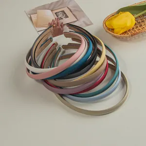 Detail of colorful matte satin headbands with anti-slip velvet lining and textured finish