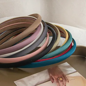 Close-up of padded sponge headbands in multiple solid colors with soft fabric texture