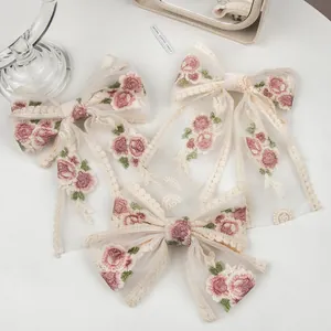Three-piece set of elegant lace mesh bow hair clips with floral embroidery and long ribbons