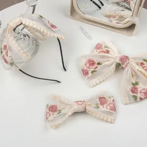 Floral embroidery mesh bow clips and headband set with pink flowers on white background