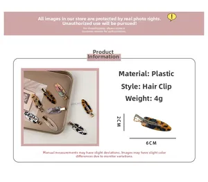 Detail view of cellulose acetate hair clips showing 6cm x 2cm size and 4g weight specs