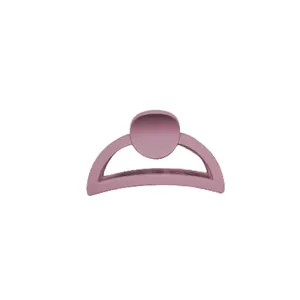 Matte dusty pink hollow hair claw clip in a minimalist cream color palette for women
