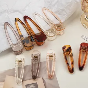 Close-up of transparent acrylic hair clips in leopard print and amber brown tones