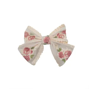 Elegant cream mesh lace hair bow clip featuring detailed floral rose embroidery