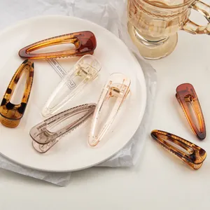 Minimalist transparent resin hair clips in tortoiseshell and amber colors for women
