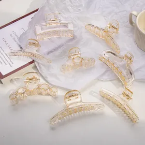 Detailed set of eight amber acrylic hair claws in various geometric shapes for women