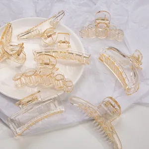 Elegant amber transparent geometric hair claw clips set in various shapes on a tray