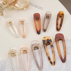 Detail view of 10-piece resin duckbill hair clips in amber and tortoiseshell patterns
