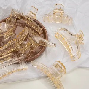 Set of minimalist amber geometric hair claws in transparent acrylic with metal springs