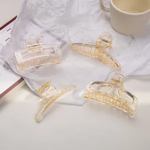 Set of four champagne transparent hair claws with durable metal springs in varied shapes