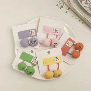 Detail of 5-piece cherry embroidery hair ties set in candy colors on display card