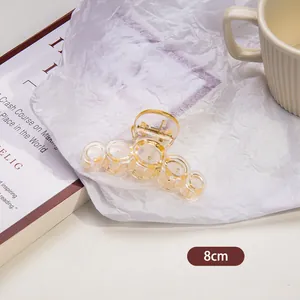 Close-up of 8cm transparent amber hair claw clip with elegant gold foil flakes