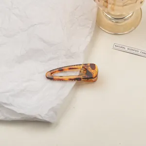 Detail of amber tortoiseshell hair clip with waterdrop hollow design and anti-slip teeth