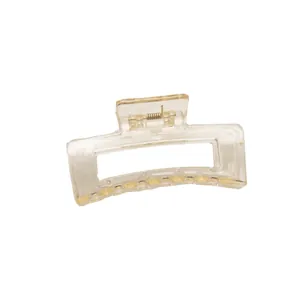 Minimalist rectangular transparent hair claw clip with golden metal spring on white background